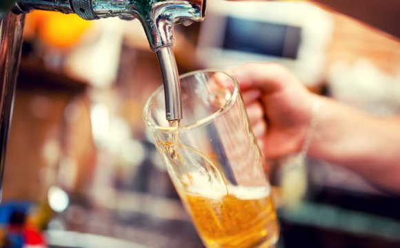 Barman pouring beer