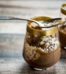 This easy no-bake pot de creme recipe utilizes a blender to achieve the perfect texture. Topped with German Chocolate Cake frosting, these treats are entirely irresistible!
